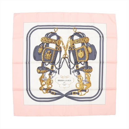 Hermès Carré 90 “Brides de Gala” silk scarf in pink with equestrian-inspired print in gold and gray on white background, bordered in soft pink.