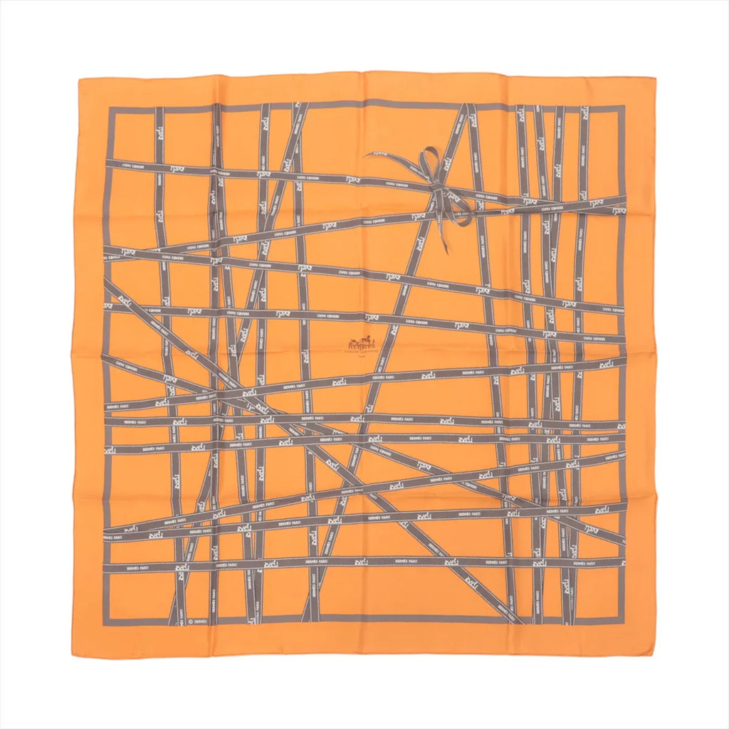 Hermès Carré 90 orange silk scarf with gray Bolduc ribbon print, crisscrossing ribbon lines, and a tied bow motif on white background