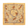 Hermès Carré 90 “Casse Noisette” silk scarf in yellow with brown border and woodland illustration of squirrels among branches and leaves.