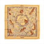 Hermès Carré 90 “Casse Noisette” silk scarf in yellow with brown border and woodland illustration of squirrels among branches and leaves.