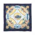 Hermès Carré 90 navy blue silk scarf with circular equestrian scenes, riders on horseback, desert vignettes, tassel-style border accents, and multicolor detailing on white background