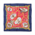 Hermès Carré 90 silk scarf in navy blue and red with gold lasso design, cowboy and horse illustrations, and green ornate border details.