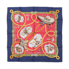 Hermès Carré 90 silk scarf in navy blue and red with gold lasso design, cowboy and horse illustrations, and green ornate border details.