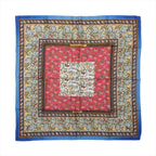 Blue Hermès Carré 90 silk scarf with red and ivory panels, intricate hunting scenes, animal motifs and ornate patterned borders.