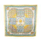 Hermès Carré 90 yellow, pale blue and ivory silk scarf with Byzantine-inspired mosaic panels, arches, birds and ornate geometric borders.