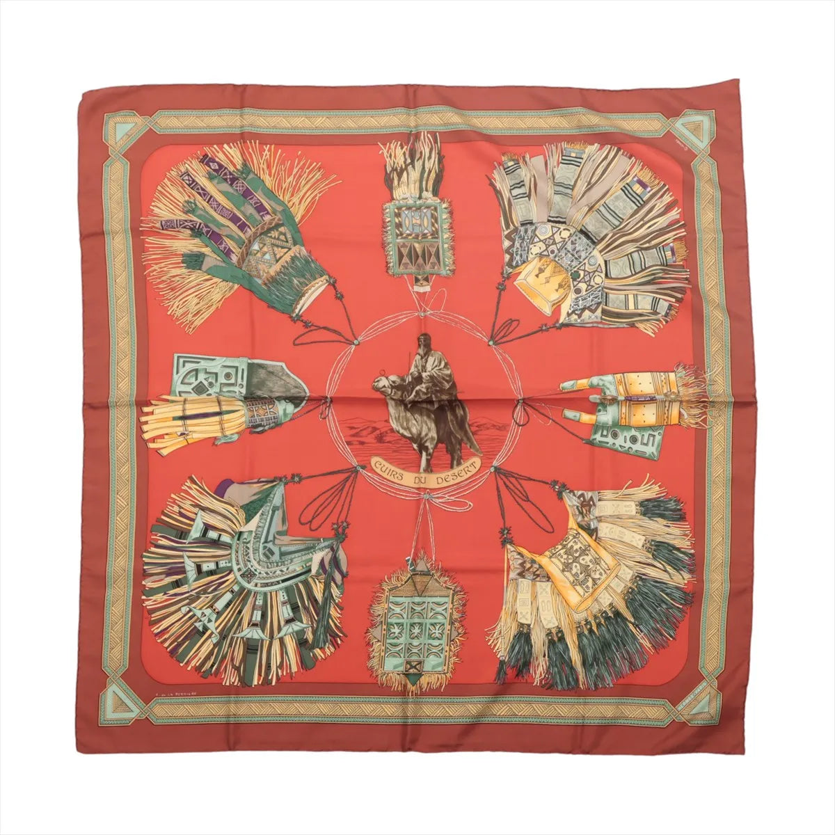 Hermès Carré 90 silk scarf in red and brown with equestrian figure, ornate tassels, leatherwork motifs and decorative geometric border.