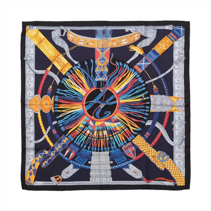 Hermès Carré 90 "Ceintures et Liens" silk scarf in navy blue featuring an intricate central circular design composed of multicolored belts, cords, and ornamental buckles radiating outward with metallic silver, gold, red, blue, and yellow detailing.
