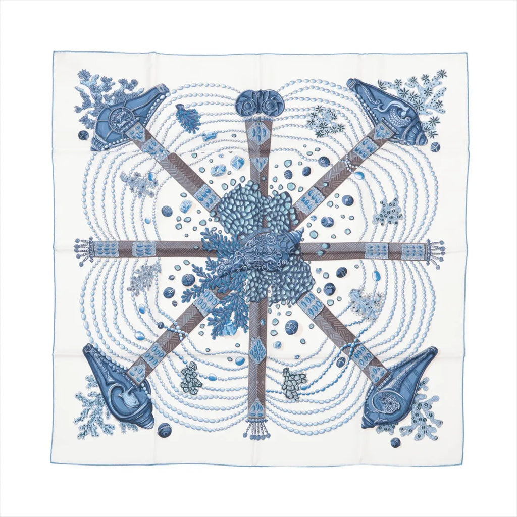 Hermès Carré 90 "Chemins de Corail" silk handkerchief in blue, featuring a detailed design of coral, pearls, and sea-inspired patterns arranged in a circular layout, displayed flat against a white background.