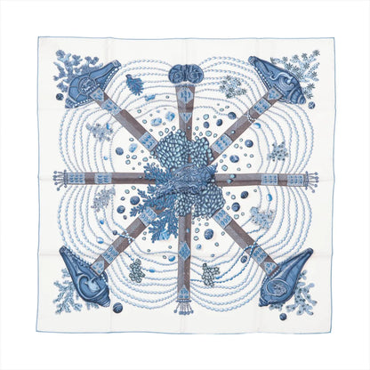 Hermès Carré 90 "Chemins de Corail" silk handkerchief in blue, featuring a detailed design of coral, pearls, and sea-inspired patterns arranged in a circular layout, displayed flat against a white background.