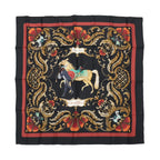 Hermès Carré 90 “Cheval Turc” silk scarf in black with red border, ornate gold scrollwork frame, and central horse and figure illustration.