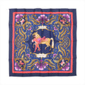 Hermès Carré 90 navy silk scarf with ornate gold baroque scrollwork, pink decorative accents, and central horse and figure illustration, framed by a red border.
