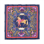 Hermès Carré 90 navy silk scarf with ornate gold baroque scrollwork, pink decorative accents, and central horse and figure illustration, framed by a red border.