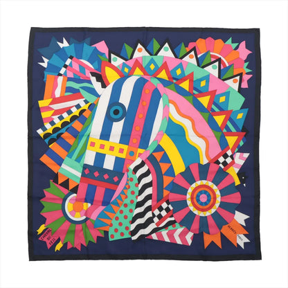 Hermès Carré 90 "Cheval de Fête" silk scarf featuring a colorful abstract horse design with geometric and ribbon patterns in pink, blue, green, orange, and yellow on a navy background, displayed flat.