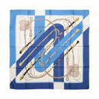 Flat view of a blue and ivory Hermès Carré 90 silk scarf with diagonal stripes, riding crops, reins and equestrian tack illustrations.