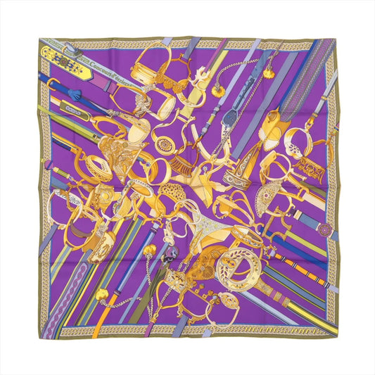 Hermès Carré 90 silk scarf in purple featuring an intricate gold equestrian motif with stirrups and straps, titled "Concours d'Étriers Etelier."
