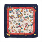 Hermès Carré 90 navy silk scarf with red braided border and cream center featuring multicolor illustrated eggs and scattered feather motifs.