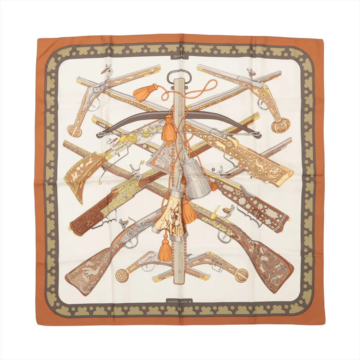 Hermès Carré 90 "Diane Gunshot" silk handkerchief in brown, featuring an ornate pattern of antique firearms and crossbows arranged symmetrically on a cream background, bordered with a burnt orange and olive green clover motif.