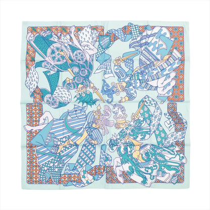 Hermès Carré 90 "Duels Oniriques" silk scarf in blue featuring four intricately illustrated armored knights in dynamic jousting poses, set against a mint green background with geometric and patterned borders in orange, white, and teal.