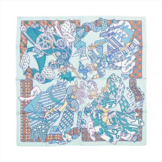 Hermès Carré 90 "Duels Oniriques" silk scarf in blue featuring four intricately illustrated armored knights in dynamic jousting poses, set against a mint green background with geometric and patterned borders in orange, white, and teal.