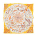 Yellow Hermès Carré 90 double-face silk scarf laid flat with intricate animal and botanical motifs, central circular tree and star design, and yellow border on white background.