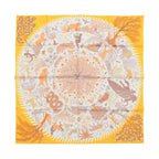 Yellow Hermès Carré 90 double-face silk scarf laid flat with intricate animal and botanical motifs, central circular tree and star design, and yellow border on white background.