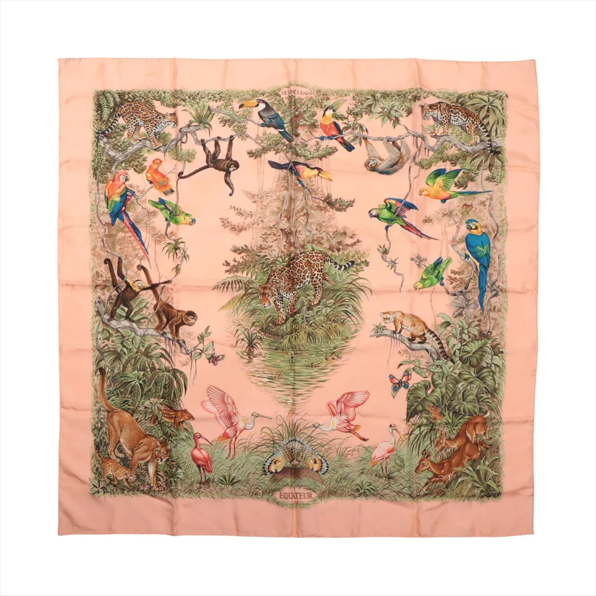 Hermès Carré 90 "Équateur" silk handkerchief in pink, featuring a detailed tropical jungle design with leopards, monkeys, parrots, toucans, flamingos, and lush greenery, bordered by a soft pink frame and centered around a large tree.