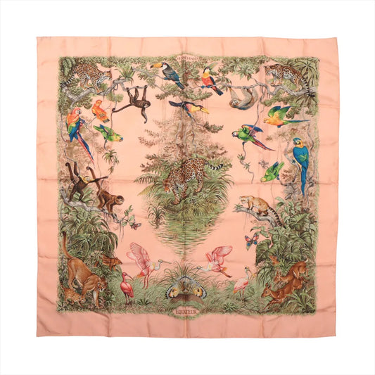 Hermès Carré 90 "Équateur" silk handkerchief in pink, featuring a detailed tropical jungle design with leopards, monkeys, parrots, toucans, flamingos, and lush greenery, bordered by a soft pink frame and centered around a large tree.
