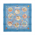 Blue Hermès Carré 90 silk scarf laid flat with multicolor Mediterranean-themed illustration in circular vignettes and a decorative border on a white background.