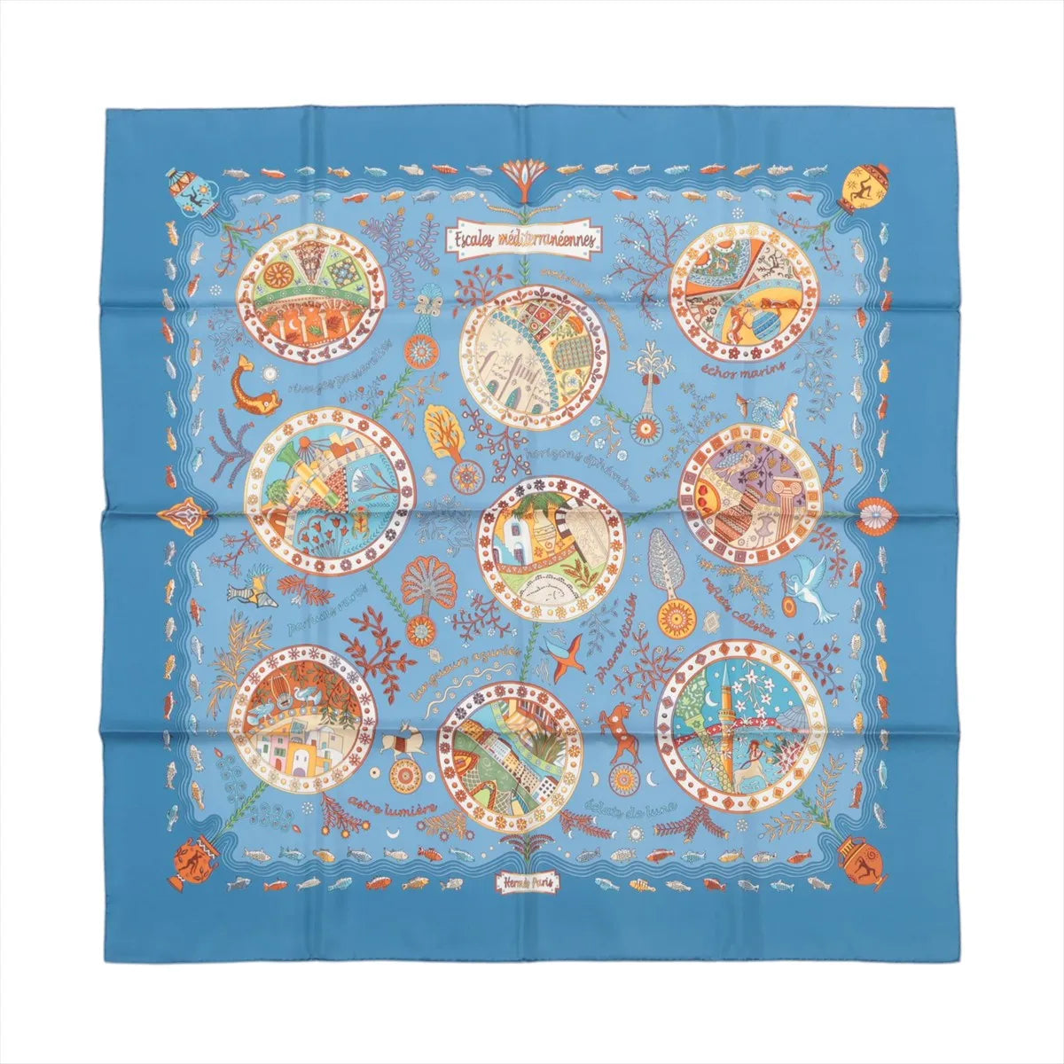 Blue Hermès Carré 90 silk scarf laid flat with multicolor Mediterranean-themed illustration in circular vignettes and a decorative border on a white background.