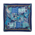 Hermès navy blue cashmere-silk scarf with layered turquoise, pale blue and white flags, ornate patterns and a striped rope border.
