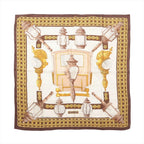 Hermès Carré 90 brown and ivory silk scarf with ornate carriage lanterns, gold lattice borders and a central horse-drawn coach motif.