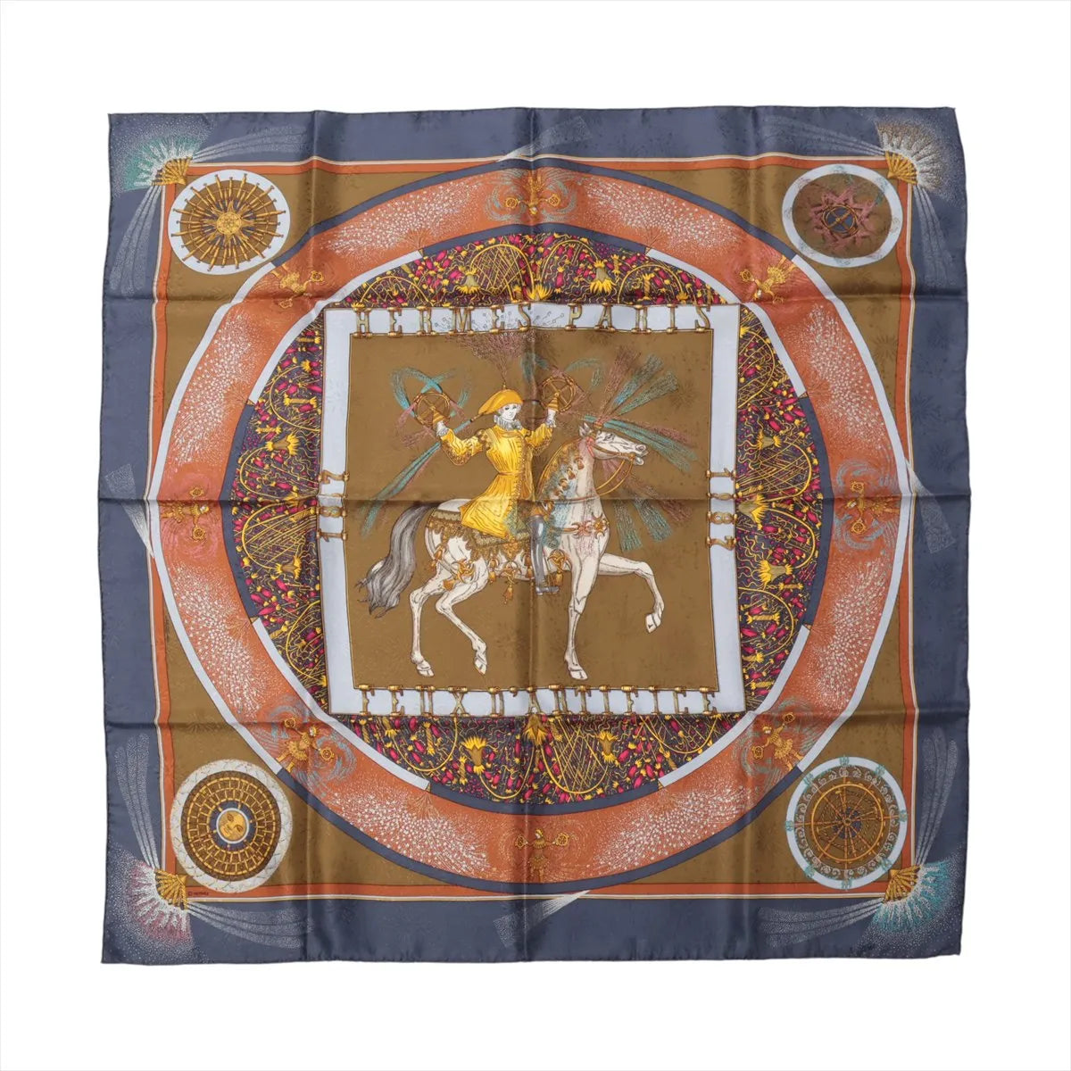 Hermès Carré 90 "Feux d’Artifice" silk scarf in navy blue and brown, featuring a central figure of a horseman in yellow surrounded by radiating fireworks and intricate circular patterns in red, gold, and white, framed by a rich decorative border.