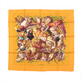 Hermès Carré 90 orange silk scarf with multicolor wildlife collage motif and green foliage accents, laid flat