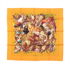 Hermès Carré 90 orange silk scarf with multicolor wildlife collage motif and green foliage accents, laid flat