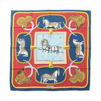 Hermès Carré 90 navy and red silk scarf with “Grand Apparat” horse and harness illustration, gold saddle motifs, braided rope details, and central framed horse design.