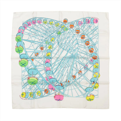 Hermès Carré 90 "Grande Roue" silk handkerchief in white and light blue, depicting a large Ferris wheel with pastel-colored gondolas in pink, green, yellow, orange, and blue, laid flat against a white background.