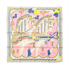 Hermès Carré 90 pink silk scarf with two illustrated horses in ornate harnesses, feather plumes, heart details, and a gray border with blue and yellow trim.
