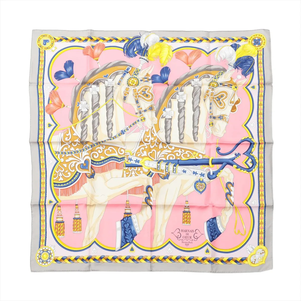 Hermès Carré 90 pink silk scarf with two illustrated horses in ornate harnesses, feather plumes, heart details, and a gray border with blue and yellow trim.