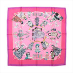 Hermès Carré 90 "HELLO DOLLY" silk scarf in pink featuring detailed illustrations of antique dolls, toys, and ribbon accents with a bold fuchsia border and central seated doll design, laid flat against a white background.