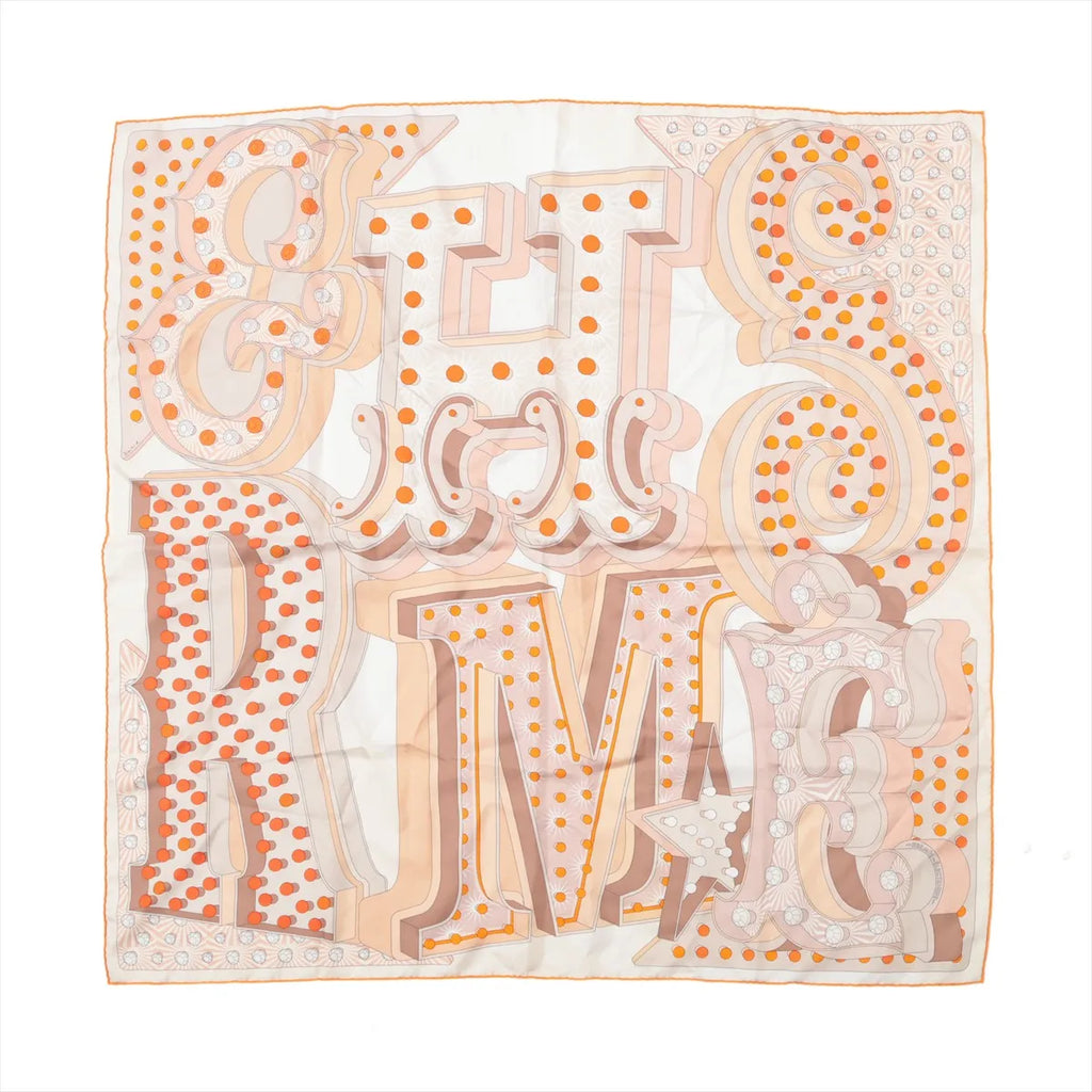 Beige Hermès Carré 90 silk scarf with oversized sculptural lettering, orange polka-dot accents, stars and a fine orange border.