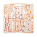 Beige Hermès Carré 90 silk scarf with oversized sculptural lettering, orange polka-dot accents, stars and a fine orange border.