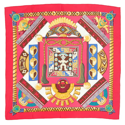Hermès Carré 90 "HUACA PIRU" silk scarf in pink featuring vibrant geometric patterns, tribal figures, and ornamental details inspired by ancient Peruvian culture, bordered in bold pink.