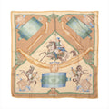 Hermès Carré 90 beige silk scarf with green, blue and gold equestrian motifs, horses, a mounted rider and ornate accessories.