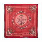 Hermès Carré 90 red cashmere-silk scarf with pink floral garlands, lattice pattern, green ornamental details and birds in a central medallion.