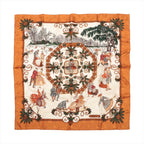 Hermès Carré 90 brown and ivory silk scarf with illustrated winter scenes, dancing figures, snowy trees and ornate green botanical scrollwork.