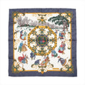 Hermès Carré 90 "Joies d’Hiver" silk scarf in navy blue, depicting vintage-style ice skaters in colorful winter clothing surrounded by gold and floral motifs.