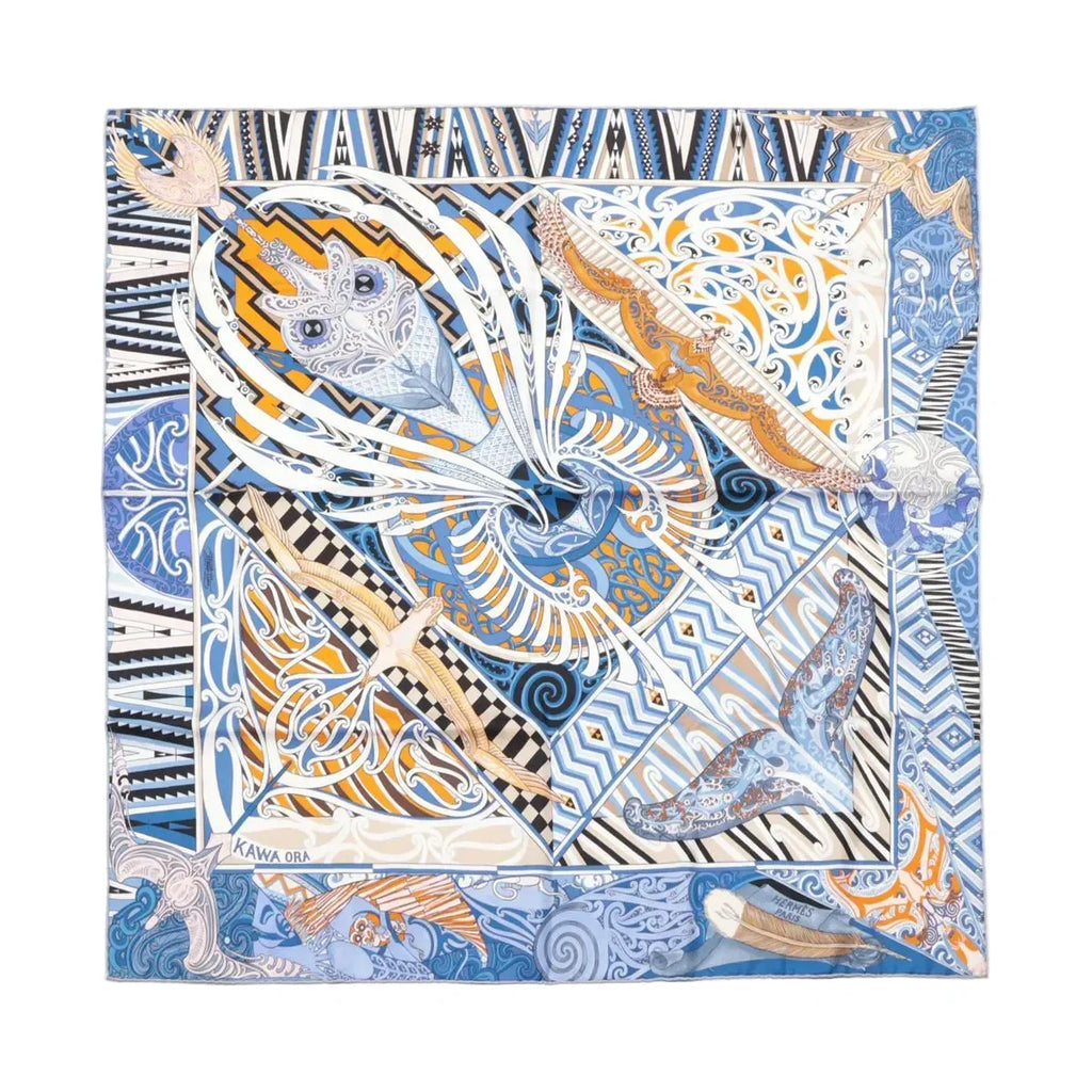 Hermès Carré 90 silk scarf in blue with multicolor abstract motif, black-and-white geometric border, and bird and fish illustrations, laid flat