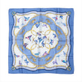 Hermès Carré 90 blue silk scarf with flying birds in blue and pink, ornate gold scrollwork circles, and a blue border with patterned corner details.