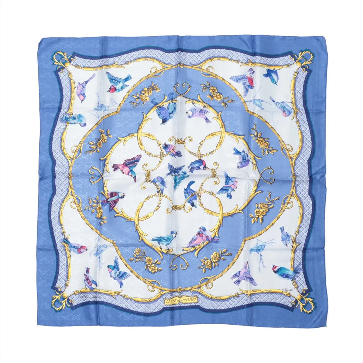 Hermès Carré 90 blue silk scarf with flying birds in blue and pink, ornate gold scrollwork circles, and a blue border with patterned corner details.