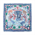 Hermès Carré 90 blue silk scarf with central elephant, giraffes, crocodiles, zebra, floral border, and multicolor wildlife motif on white background
